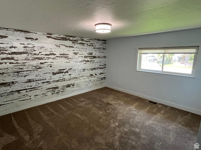 552 W 1200 N, Lehi, UT 84043 - empty room featuring baseboards, dark colored carpet, a textured ceiling, and wood walls