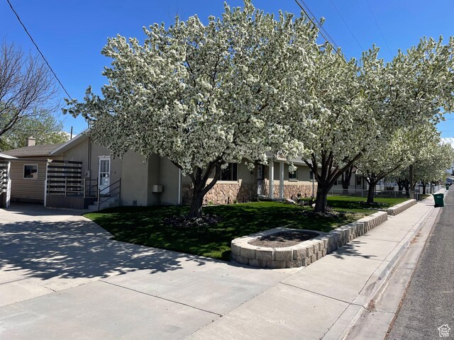 552 W 1200 N, Lehi, UT 84043 - view of front of home with stone siding, stucco siding, concrete driveway, and a front yard