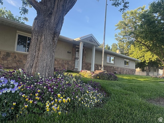 552 W 1200 N, Lehi, UT 84043 - view of home's exterior with stone siding, stucco siding, and a yard