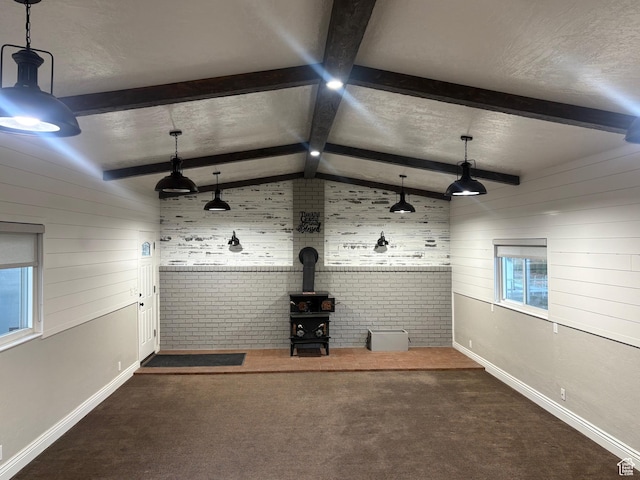 552 W 1200 N, Lehi, UT 84043 - unfurnished living room with wooden walls, a wood stove, carpet flooring, baseboards, and a textured ceiling