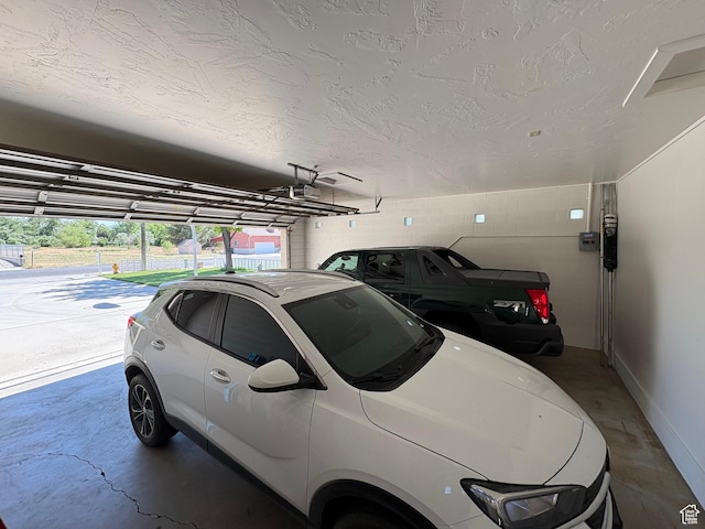 552 W 1200 N, Lehi, UT 84043 - garage featuring a garage door opener, concrete block wall, and baseboards