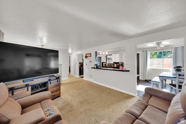 1657 N 1500 W, Clinton, UT 84015 - carpeted living area featuring a textured ceiling, baseboards, and a ceiling fan