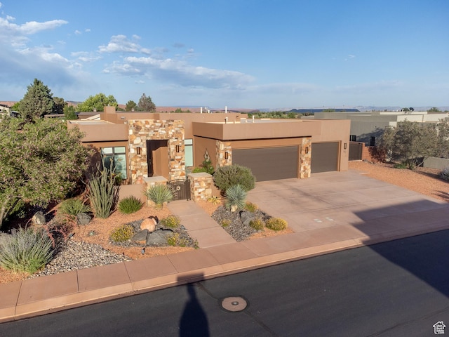 97 S 495 W, Ivins, UT 84738 - adobe home with stucco siding, a garage, driveway, stone siding, and a gate