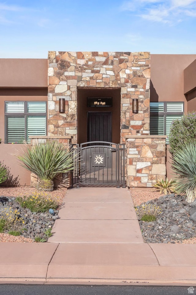 97 S 495 W, Ivins, UT 84738 - doorway to property featuring a gate, stone siding, and stucco siding