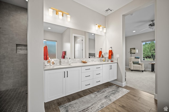 97 S 495 W, Ivins, UT 84738 - full bathroom with double vanity, wood finished floors, a ceiling fan, decorative backsplash, and baseboards
