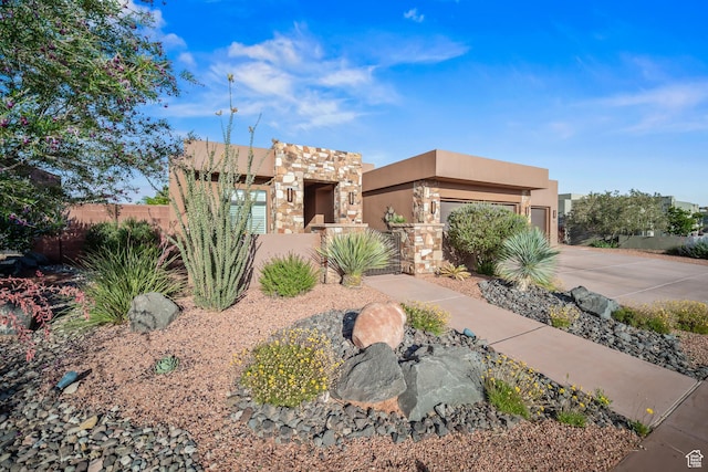 97 S 495 W, Ivins, UT 84738 - southwest-style home featuring a fenced front yard, concrete driveway, stucco siding, and a garage