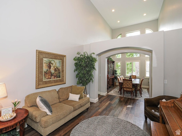 12687 S Verona Creek Way W, Riverton, UT 84065 - living area with recessed lighting, arched walkways, a high ceiling, dark wood-style floors, and baseboards