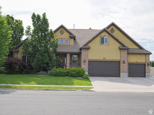 12687 S Verona Creek Way W, Riverton, UT 84065 - traditional home featuring stucco siding, a front lawn, concrete driveway, and a garage