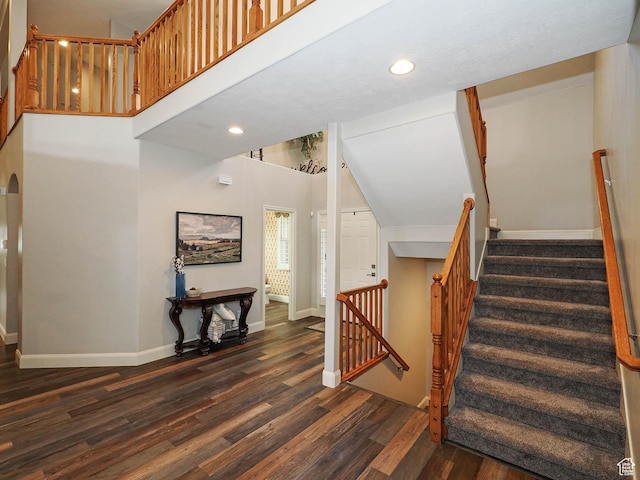 12687 S Verona Creek Way W, Riverton, UT 84065 - stairs featuring wood finished floors, baseboards, recessed lighting, and a towering ceiling