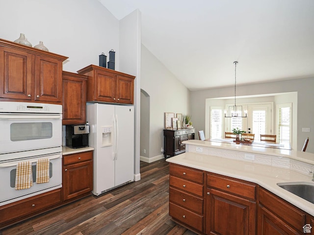 12687 S Verona Creek Way W, Riverton, UT 84065 - kitchen with white appliances, dark wood-style flooring, light countertops, and high vaulted ceiling