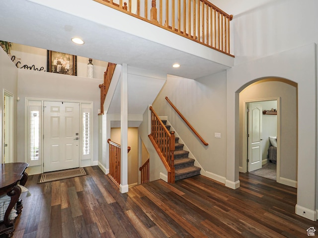 12687 S Verona Creek Way W, Riverton, UT 84065 - entryway with a high ceiling, arched walkways, baseboards, wood finished floors, and stairs
