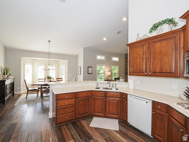 12687 S Verona Creek Way W, Riverton, UT 84065 - kitchen featuring white appliances, a sink, a peninsula, light countertops, and dark wood-style floors