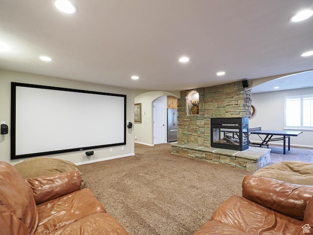 12687 S Verona Creek Way W, Riverton, UT 84065 - carpeted home theater with baseboards, arched walkways, recessed lighting, and a stone fireplace
