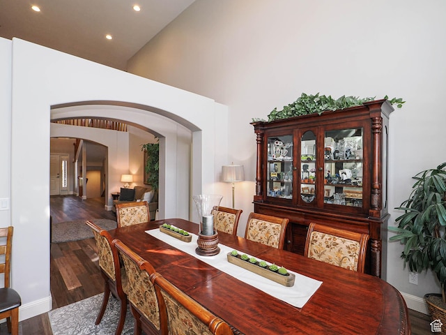 12687 S Verona Creek Way W, Riverton, UT 84065 - dining space featuring arched walkways, recessed lighting, wood finished floors, baseboards, and a high ceiling