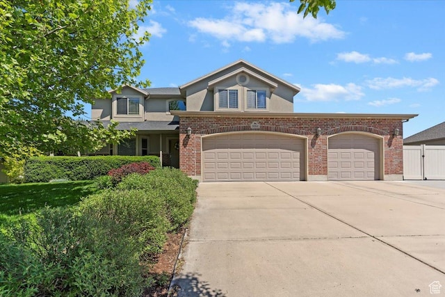 5264 S 6150 W, Hooper, UT 84315 - traditional-style home featuring concrete driveway, stucco siding, brick siding, and a garage