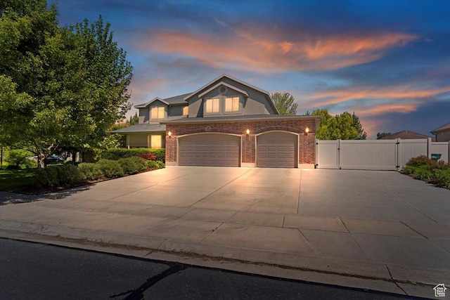 5264 S 6150 W, Hooper, UT 84315 - view of front of home featuring a gate, brick siding, driveway, and a garage
