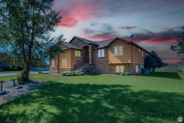 2073 S Allen Rd, Taylor, UT 84401 - property exterior at dusk featuring stone siding and stucco siding