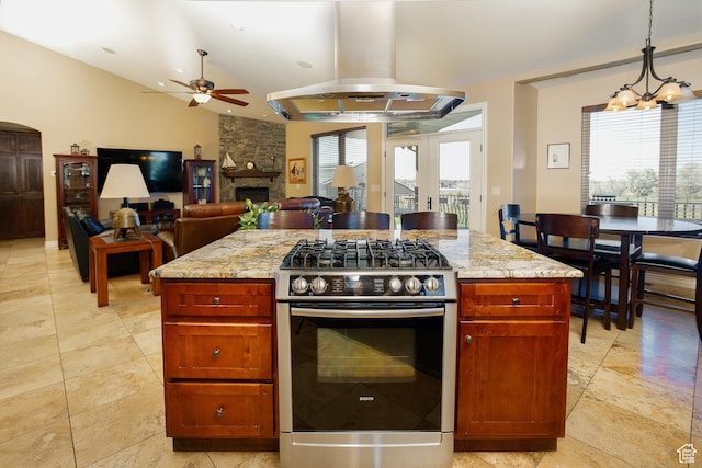 2073 S Allen Rd, Taylor, UT 84401 - kitchen with stainless steel gas stove, ceiling fan, island range hood, light stone counters, and pendant lighting