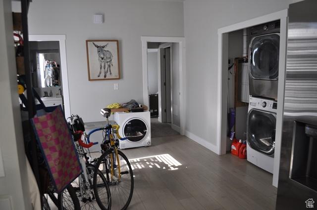 331 E Hampton Ave S, Salt Lake City, UT 84111 - laundry room with stacked washer and clothes dryer, wood finished floors, and baseboards