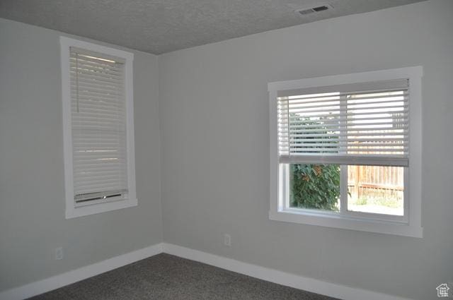 331 E Hampton Ave S, Salt Lake City, UT 84111 - unfurnished room with baseboards, dark colored carpet, and a textured ceiling
