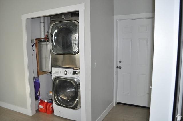 331 E Hampton Ave S, Salt Lake City, UT 84111 - washroom featuring stacked washer / dryer, baseboards, and wood finished floors