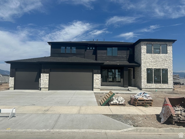 3551 S 2410 W Unit 315, Syracuse, UT 84075 - view of front of property with an attached garage, stone siding, and concrete driveway