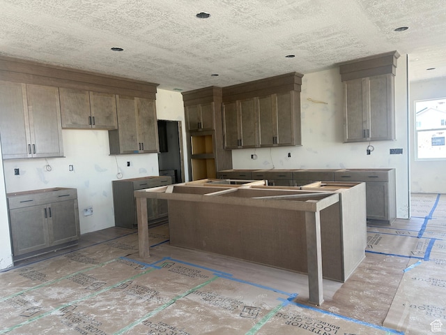 3551 S 2410 W Unit 315, Syracuse, UT 84075 - kitchen featuring a center island and a textured ceiling