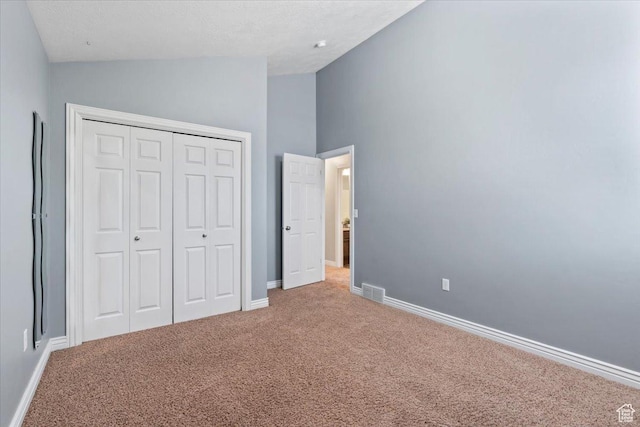 1853 W 2300 S, Woods Cross, UT 84087 - unfurnished bedroom with light colored carpet, a closet, baseboards, and high vaulted ceiling