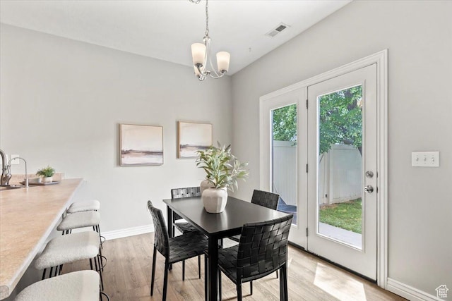 1853 W 2300 S, Woods Cross, UT 84087 - dining space featuring a chandelier, light wood-type flooring, and baseboards