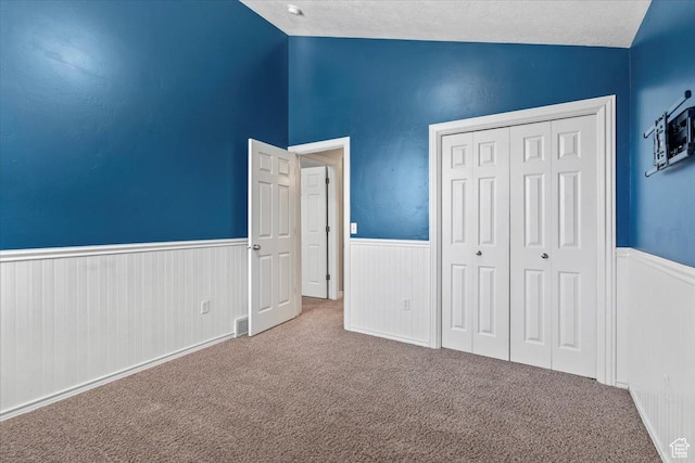 1853 W 2300 S, Woods Cross, UT 84087 - unfurnished bedroom featuring wainscoting, carpet, vaulted ceiling, a closet, and a textured ceiling
