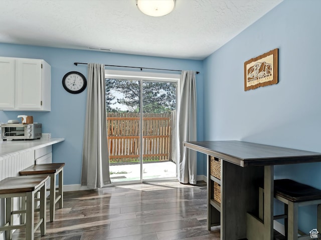 1631 E 1470 S Unit 5E, Ogden, UT 84404 - dining space featuring wood finished floors, baseboards, and a textured ceiling