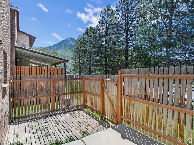 1631 E 1470 S Unit 5E, Ogden, UT 84404 - wooden terrace featuring a mountain view, a fenced backyard, and a gate