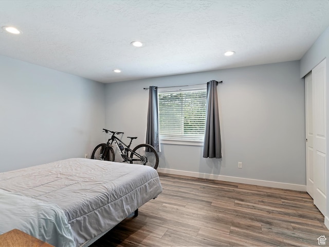 1631 E 1470 S Unit 5E, Ogden, UT 84404 - bedroom featuring wood finished floors, recessed lighting, baseboards, and a textured ceiling