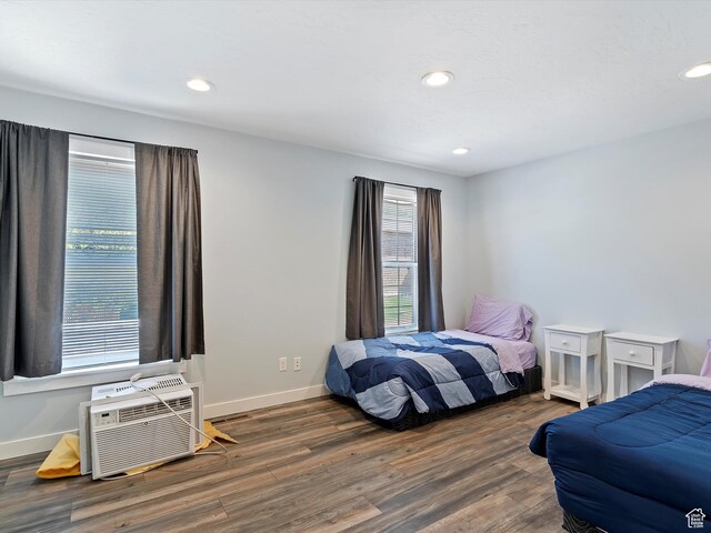 1631 E 1470 S Unit 5E, Ogden, UT 84404 - bedroom featuring wood finished floors, baseboards, recessed lighting, and a wall mounted AC