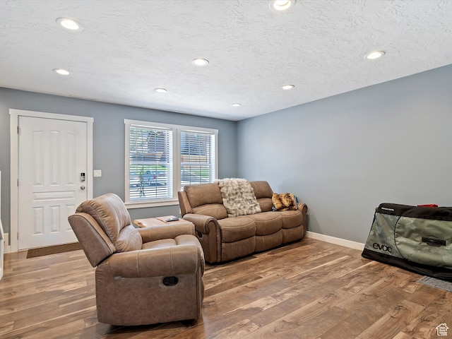 1631 E 1470 S Unit 5E, Ogden, UT 84404 - living room with wood finished floors, recessed lighting, baseboards, and a textured ceiling