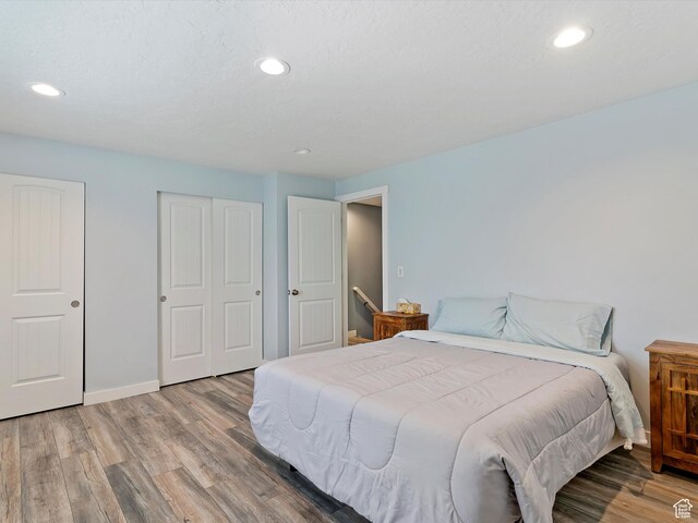 1631 E 1470 S Unit 5E, Ogden, UT 84404 - bedroom featuring wood finished floors, recessed lighting, a closet, and baseboards