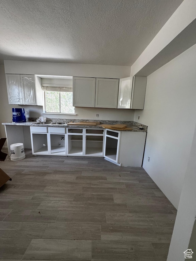 410 Rose Ave, Price, UT 84501 - kitchen featuring a textured ceiling and dark wood finished floors
