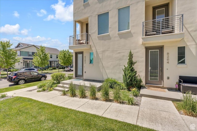 6202 W Birch Run Rd, South Jordan, UT 84009 - view of front of property featuring a balcony, stucco siding, a residential view, and a front yard