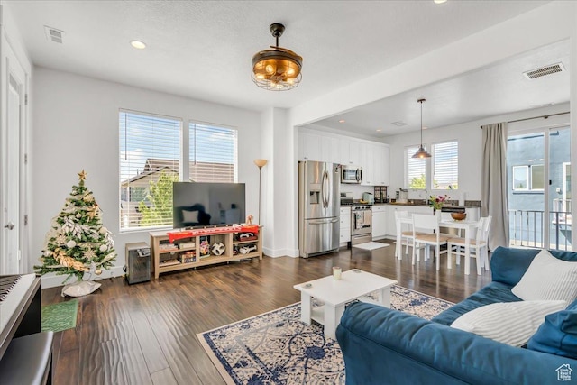 6202 W Birch Run Rd, South Jordan, UT 84009 - living room with recessed lighting and dark wood-style floors