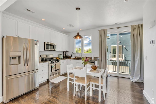 6202 W Birch Run Rd, South Jordan, UT 84009 - kitchen featuring appliances with stainless steel finishes, white cabinets, dark wood-style floors, and recessed lighting