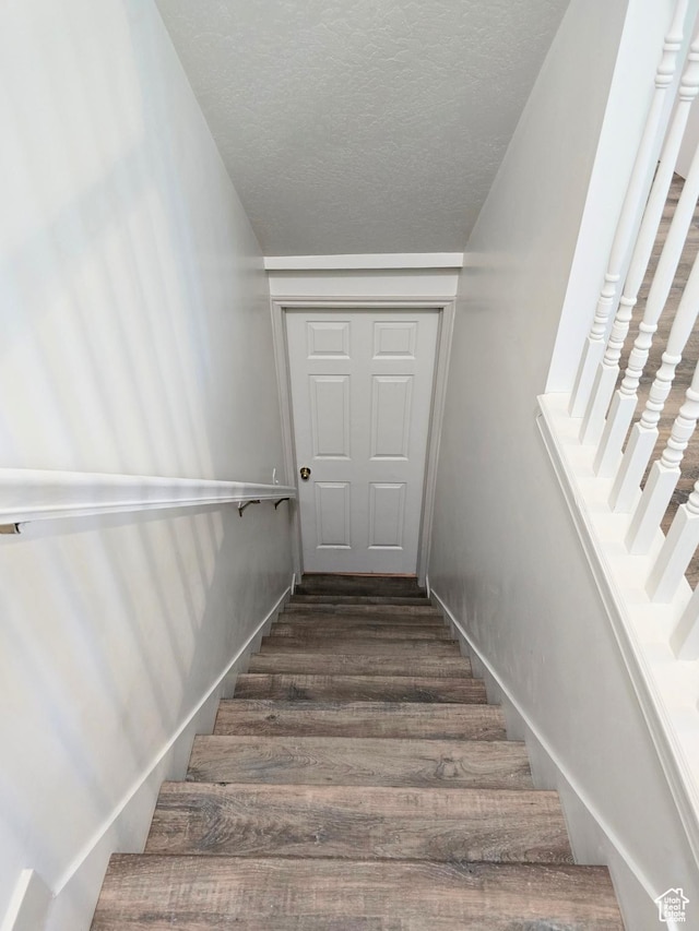 82 S Santa Rita Pl, West Jordan, UT 84088 - staircase featuring wood finished floors, a textured ceiling, and baseboards