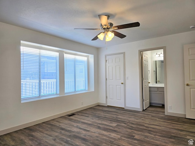 82 S Santa Rita Pl, West Jordan, UT 84088 - unfurnished bedroom with dark wood-style flooring, baseboards, ensuite bathroom, and ceiling fan