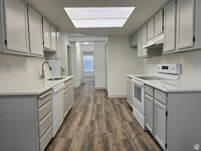 82 S Santa Rita Pl, West Jordan, UT 84088 - kitchen with white appliances, gray cabinets, under cabinet range hood, a sink, and dark wood-type flooring