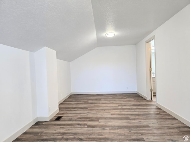 82 S Santa Rita Pl, West Jordan, UT 84088 - additional living space with lofted ceiling, a textured ceiling, wood finished floors, and baseboards