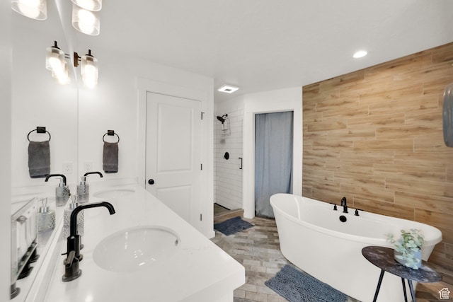 10777 S Lamond Dr W, South Jordan, UT 84009 - full bath with a stall shower, double vanity, a freestanding bath, tile walls, and recessed lighting