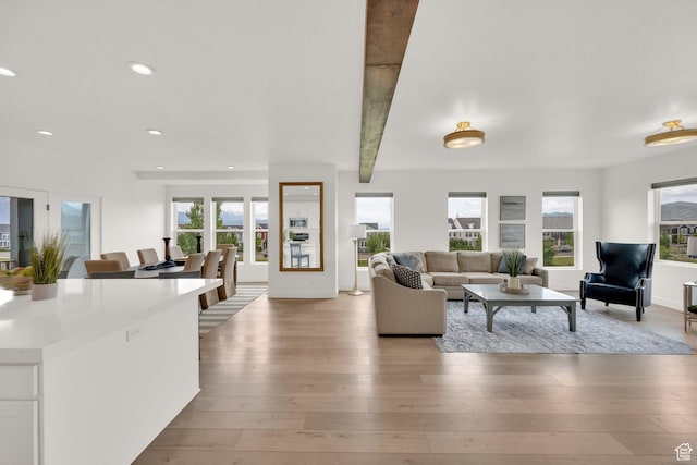 10777 S Lamond Dr W, South Jordan, UT 84009 - living room featuring healthy amount of natural light, light wood-style floors, recessed lighting, beamed ceiling, and baseboards
