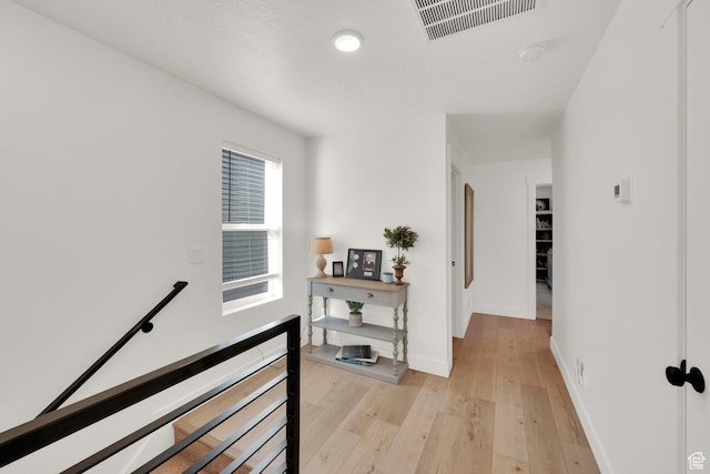 10777 S Lamond Dr W, South Jordan, UT 84009 - hall with an upstairs landing, light wood-type flooring, and baseboards