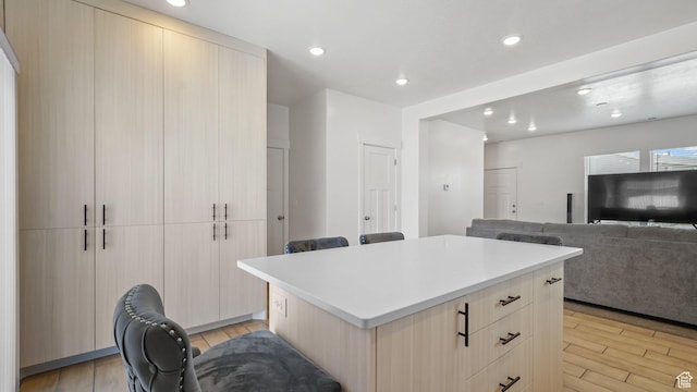 521 W 1110 N Unit Hc4, Logan, UT 84341 - kitchen with a kitchen island, light wood finished floors, recessed lighting, light countertops, and modern cabinets