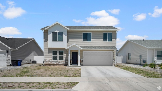 521 W 1110 N Unit Hc4, Logan, UT 84341 - view of front of property with driveway, stone siding, an attached garage, and a shingled roof