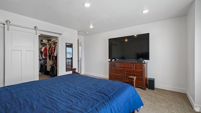 521 W 1110 N Unit Hc4, Logan, UT 84341 - bedroom featuring carpet flooring, a walk in closet, a barn door, baseboards, and recessed lighting